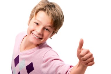 Portrait of young boy showing thumbs up clipart