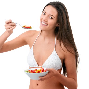 Young woman eating fruit. clipart