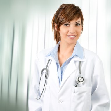 Attractive confident female doctor with stethoscope. clipart