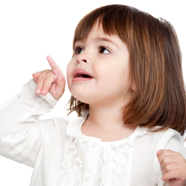 Cute little girl pointing with finger — Stock Photo, Image