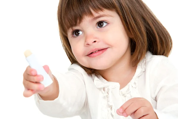 Portrait of little girl with lip balm. — Stock Photo, Image