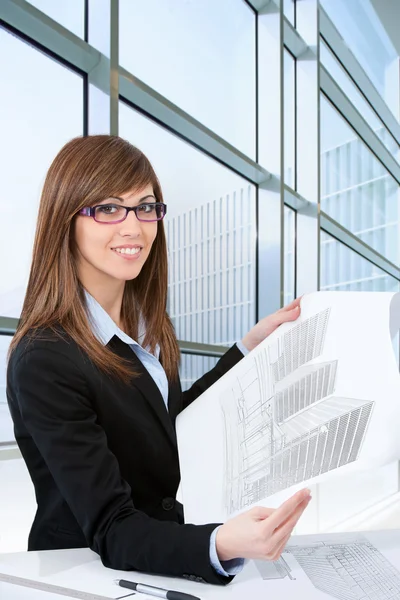 Portrait of young female architect with plans. — Stock Photo, Image