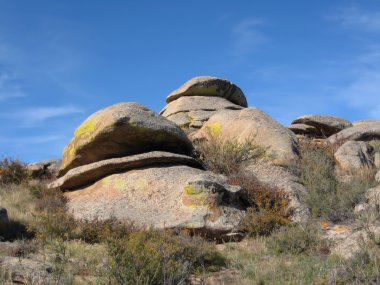 Quaint stone blocks covered with yellow lichens clipart