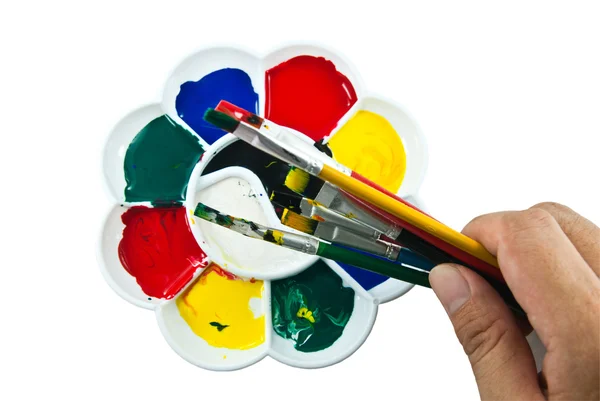 Paleta de artista com escovas na mão — Fotografia de Stock