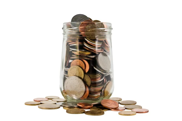 stock image Coins spilled from a jar on white