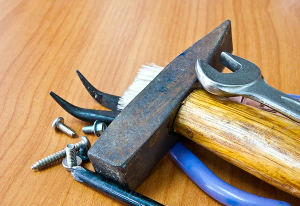 Hammer with tools on wood background — Stock Photo, Image