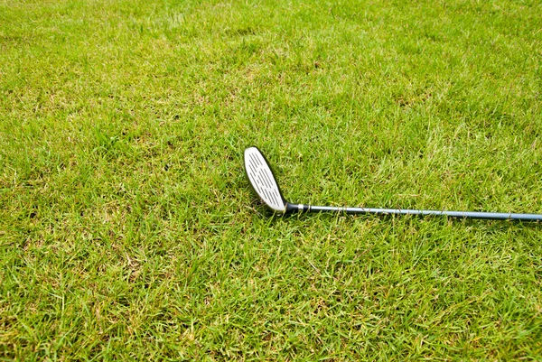Clube de golfe que coloca na grama — Fotografia de Stock