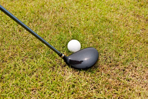 Golf ball and golf club with green grass — Stock Photo, Image