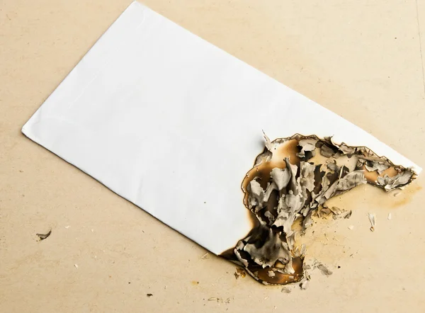 Burned white envelope — Stock Photo, Image