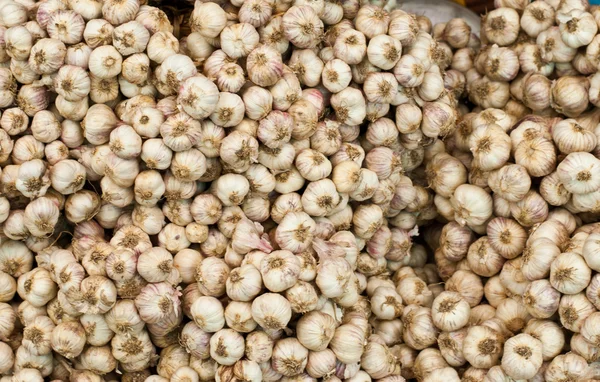 stock image Garlic stacked on a market