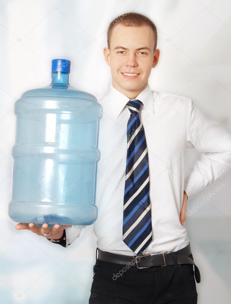 Smiling young businessman with water bottle