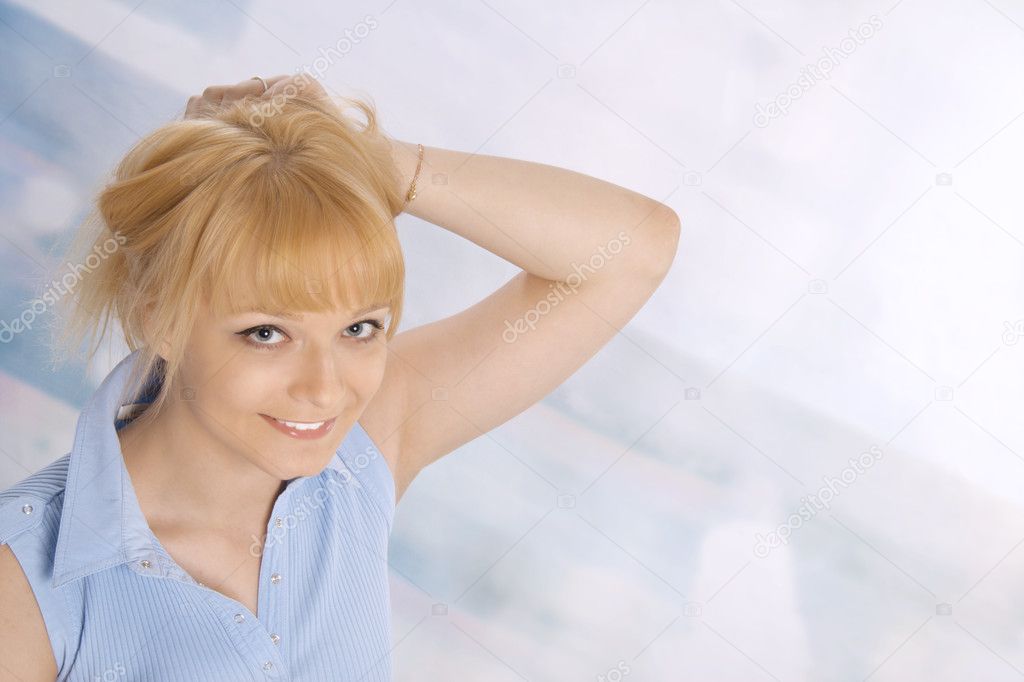 Woman leaning against blue background