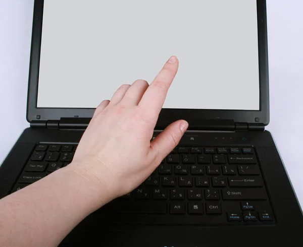 Палец руки, указывающий на ноутбук — стоковое фото