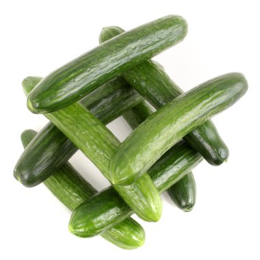 Well made of fresh green cucumbers isolated over white backgroun clipart