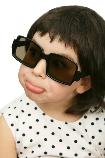 Lustiges Mädchen mit großer schwarzer Brille auf weißem Hintergrund — Stockfoto