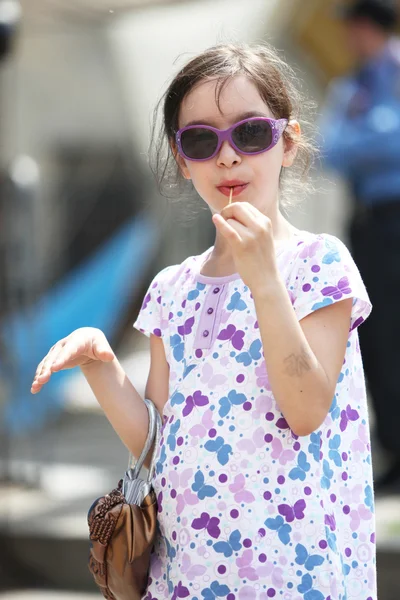 Menina se divertindo comendo pirulito — Fotografia de Stock