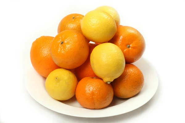 Citrus fruits on white plate — Stock Photo, Image