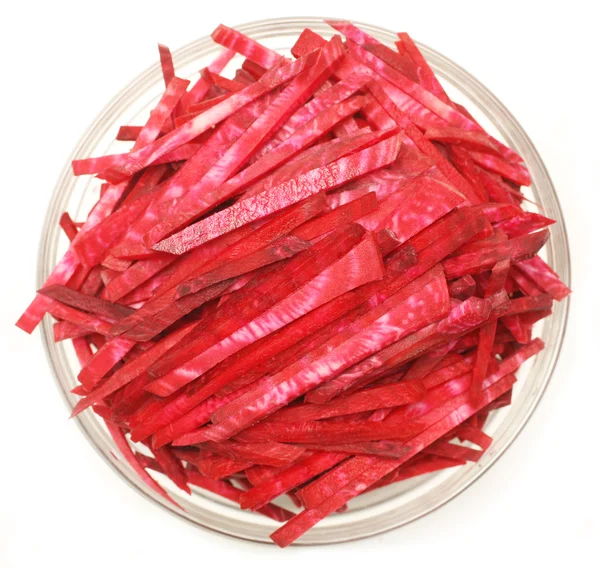 stock image Slices of uncooked beetroot in a glass bowl isolated on white