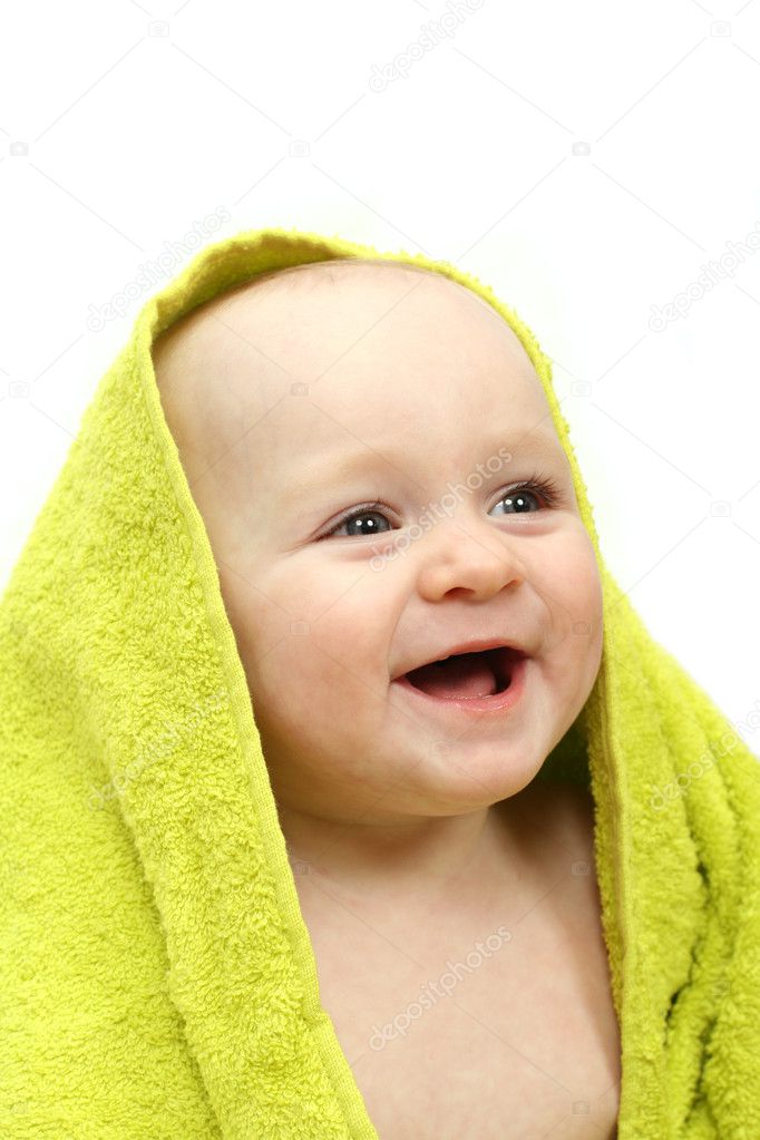 Smiling baby wrapped in a green towel on white background