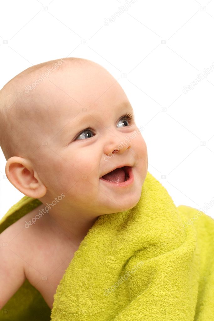 Smiling little baby wrapped in a green towel on white background