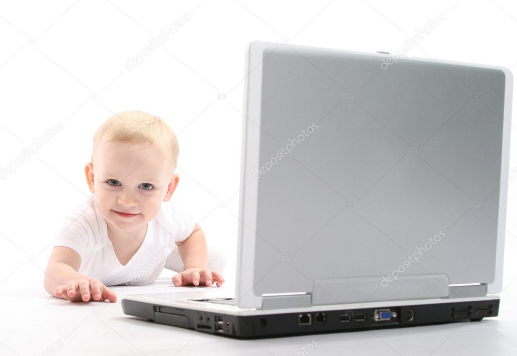 Little baby using laptop over white