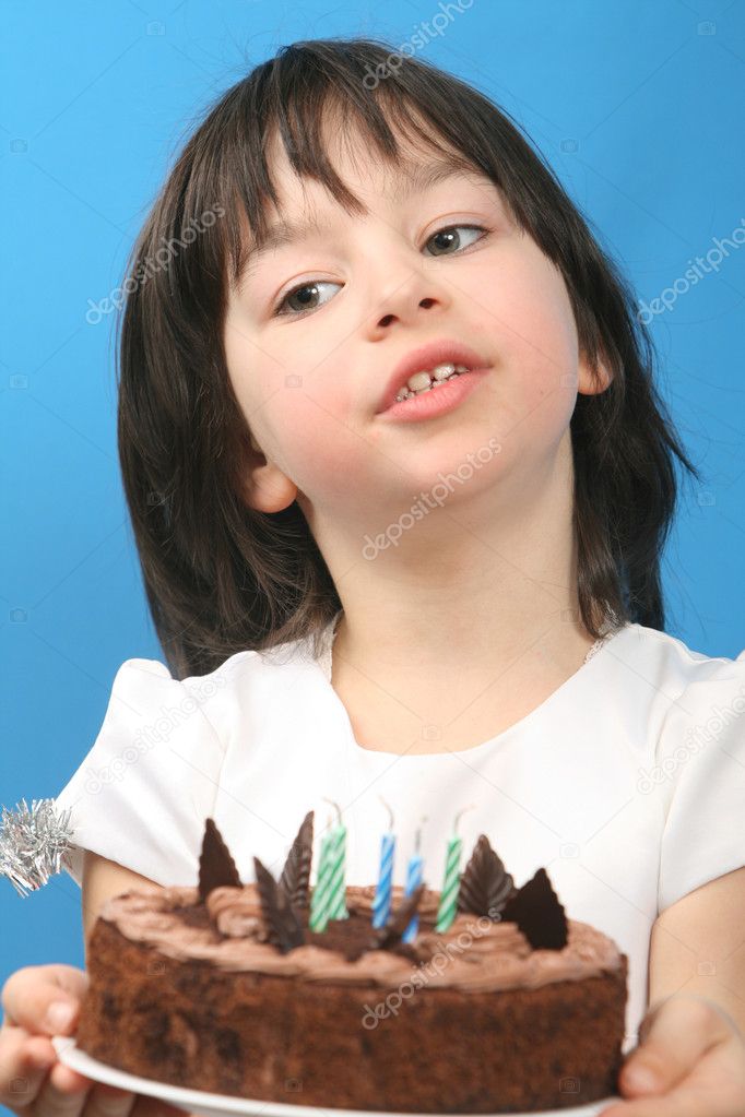 Girl with birthday cake on blue background (studio shot)