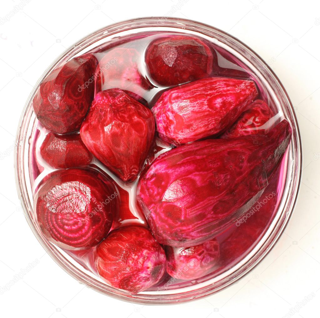 Uncooked beet in a glass bowl isolated on white