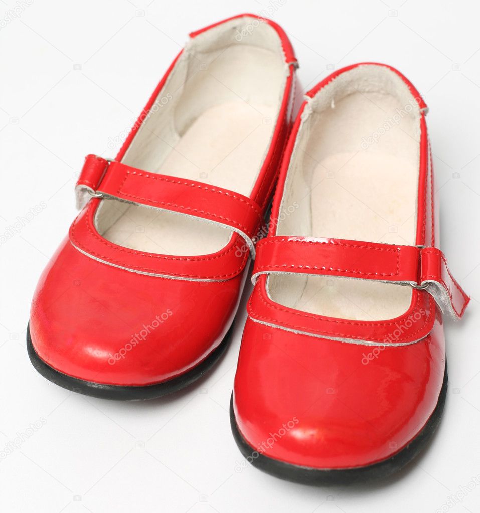 Red children's varnished shoes isolated on white background