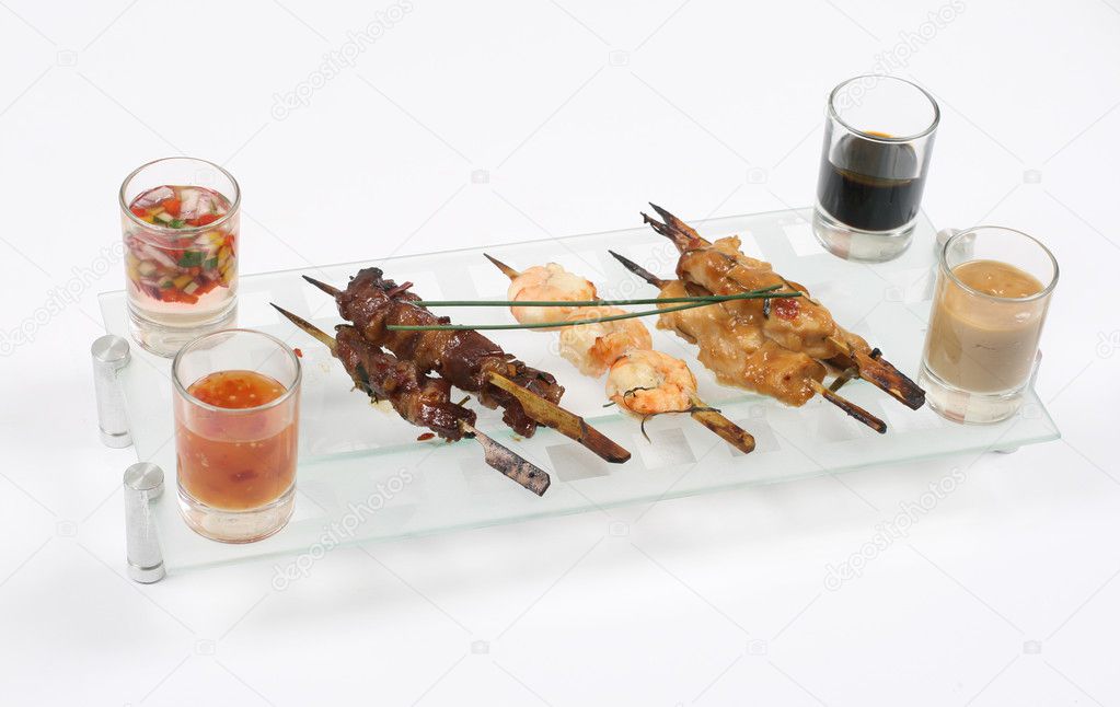 Shrimp & meat barbeque with different sauces isolated on white