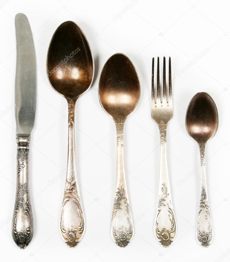 Vintage spoons, fork and knife isolated on white
