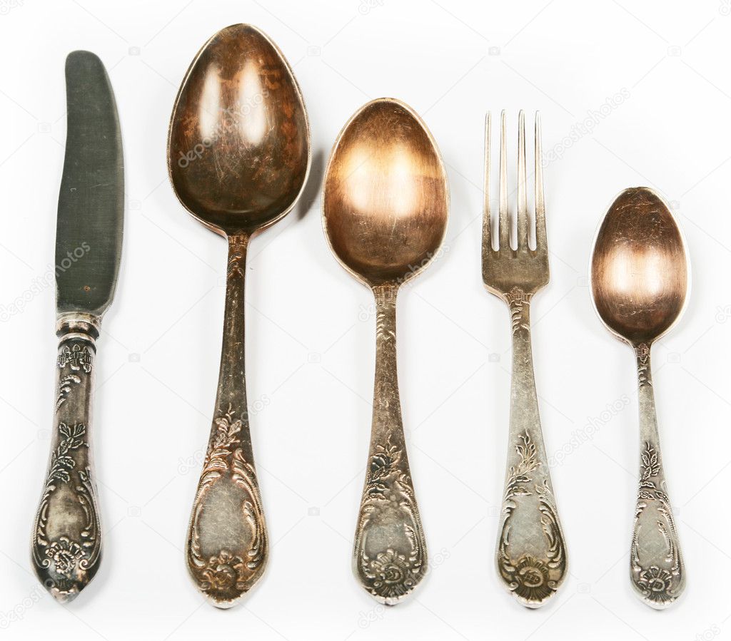 Old spoons, fork and knife isolated