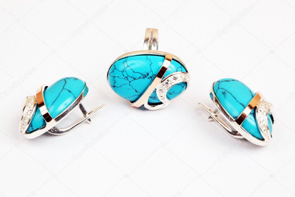 Golden earrings and ring with turquoise isolated the white backg