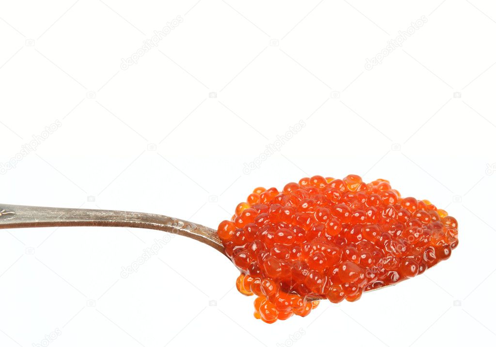 Red caviar in spoon isolated over white background