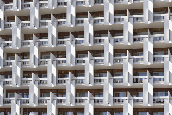 The facade of a multi-storey buildings photographed on a sunny day.
