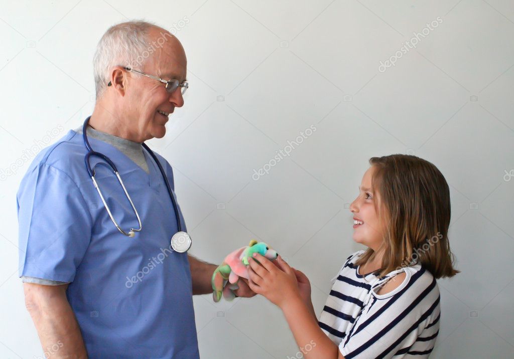 Doctor giving gift to preteen girl