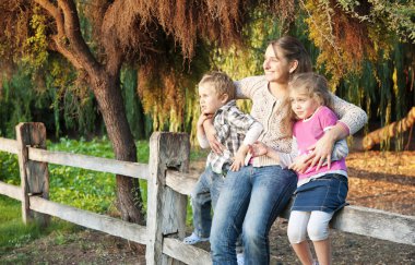 Mother and sons in a magic garden clipart