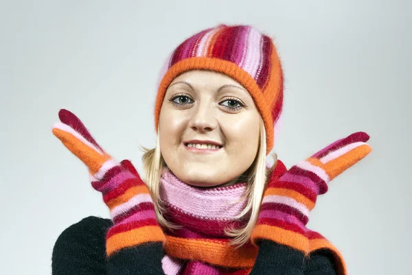 Beautiful girl in a hat and gloves, holding on to the face — Stock Photo, Image