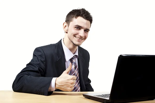 A guy with a laptop at a desk — Stock Photo, Image