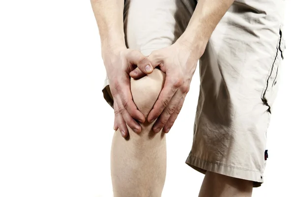 Парень, держащий колено — стоковое фото