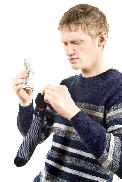 Killen lägga pengar i en strumpa — Stockfoto