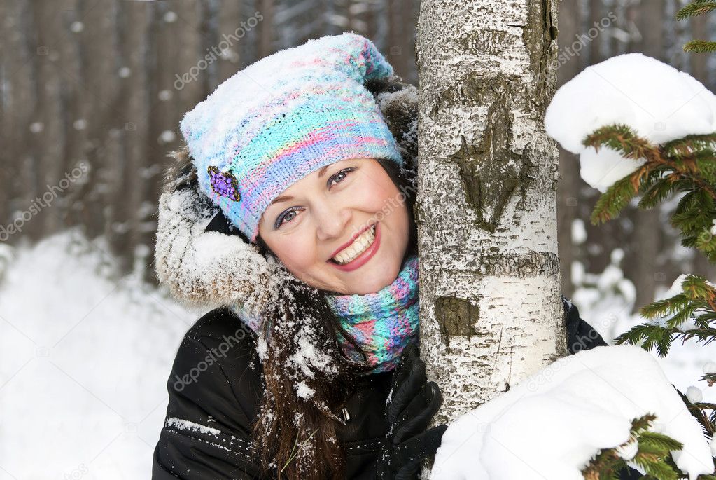 Portrait of a beautiful girl in the forest in winter