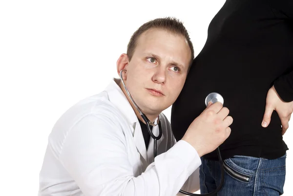 Doctor listening to pregnant girl — Stock Photo, Image