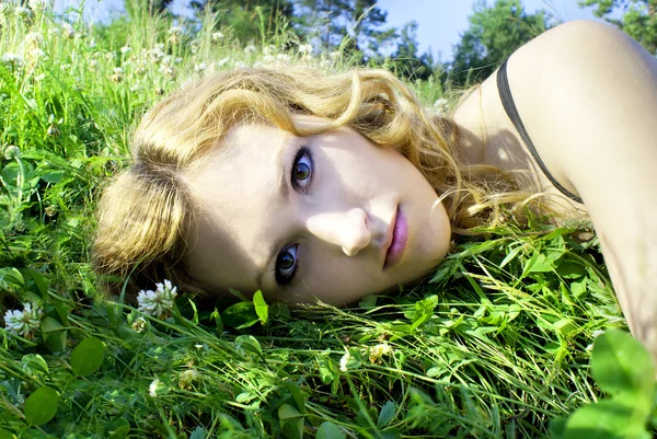 Beautiful red-haired girl in the grass — Stok fotoğraf