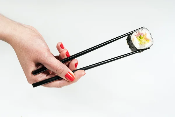 Sushi on a stick holding hand — Stock Photo, Image