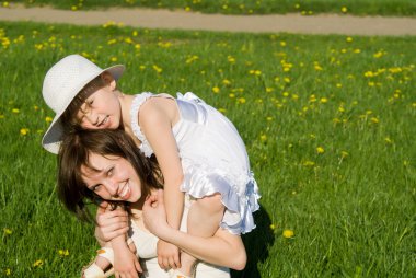 The mother plays with her daughter, in nature clipart