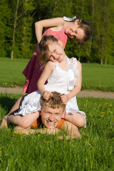 Family lies is on the meadow — Stock Photo, Image