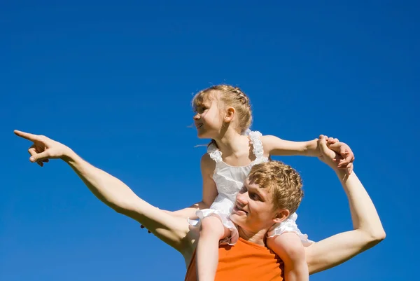 The father holds the daughter on his shoulders, and indicates — Stock Photo, Image