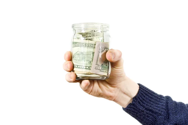 stock image Hand holds glass jar with the money
