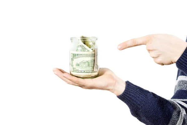 Mão segura frasco de vidro com o dinheiro apontando um dedo — Fotografia de Stock