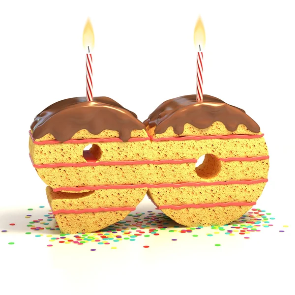 Čokoládový narozeninový dort obklopen konfety s zapálil svíčku devadesátým oslavu narozenin nebo výročí — Stock fotografie